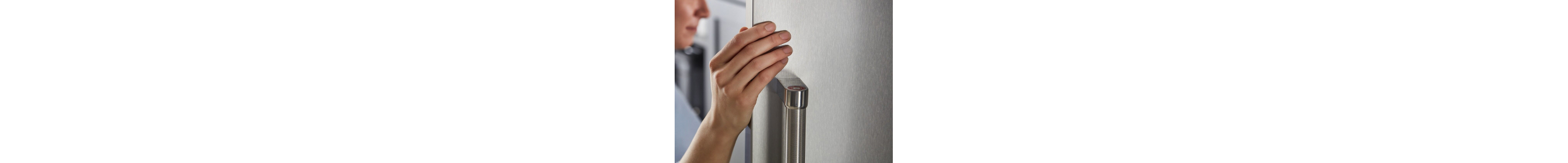 Person touching a stainless steel refrigerator door
