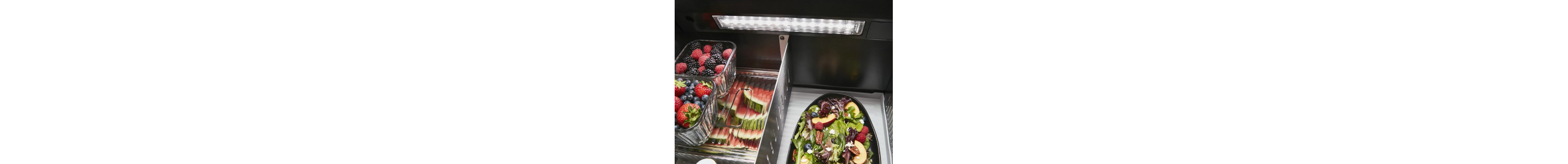 Fresh produce inside a refrigerator with LED lighting