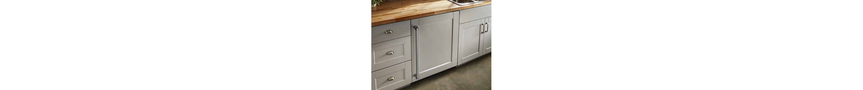 Beige cabinets with butcher block countertop