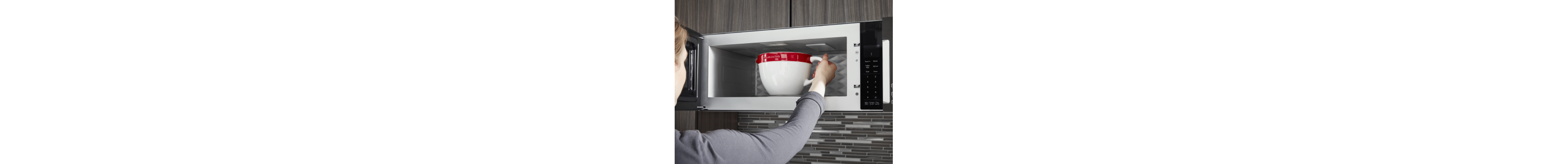 Person removing mug of water from microwave