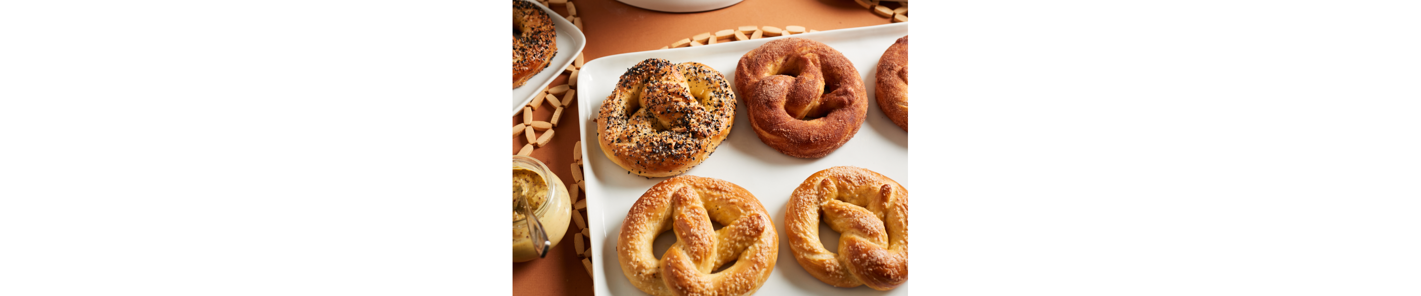 White tray full of cinnamon and sugar, salted and everything soft pretzels
