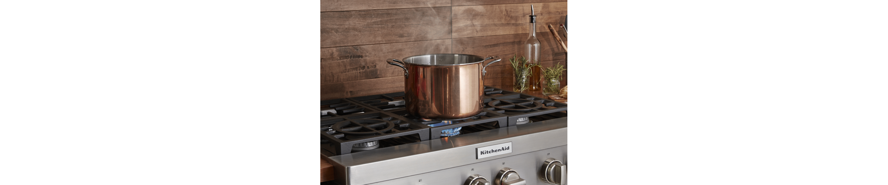 Pot sitting on a gas stove top heating above a flame