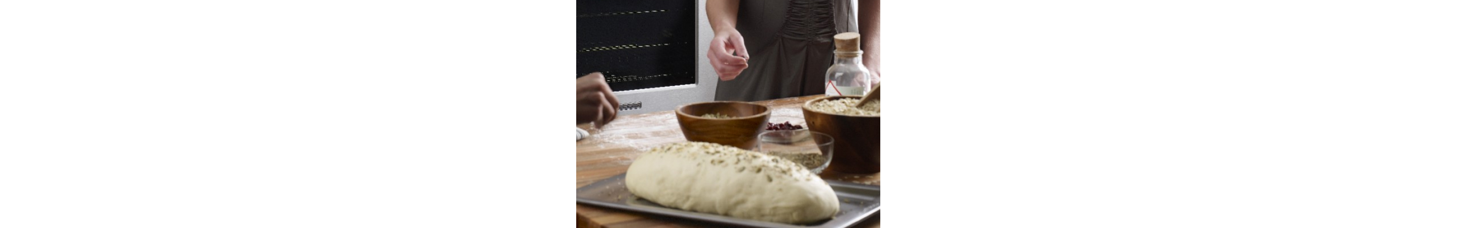 Person adding seasonings to dough