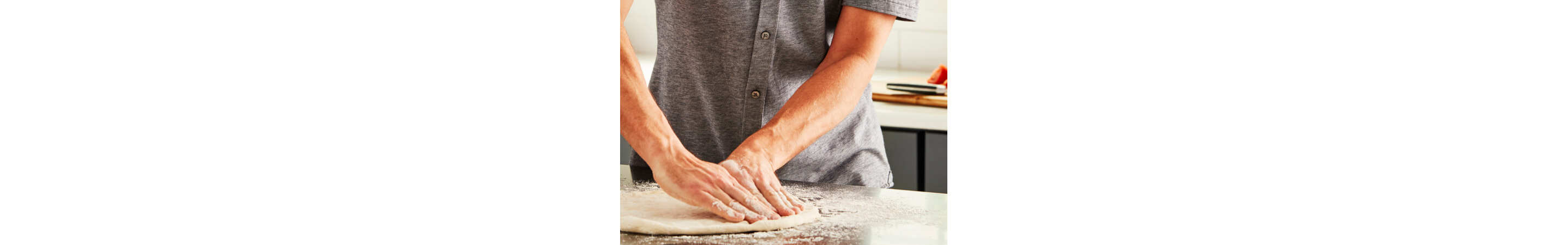 Person stretching dough