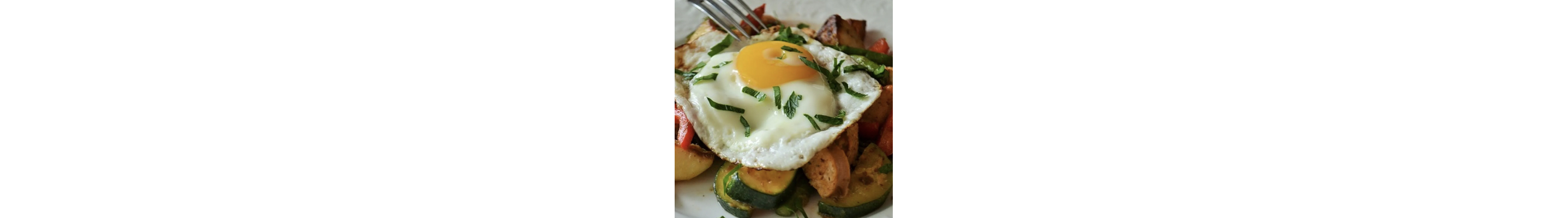 Poached egg on top of assorted roasted vegetables