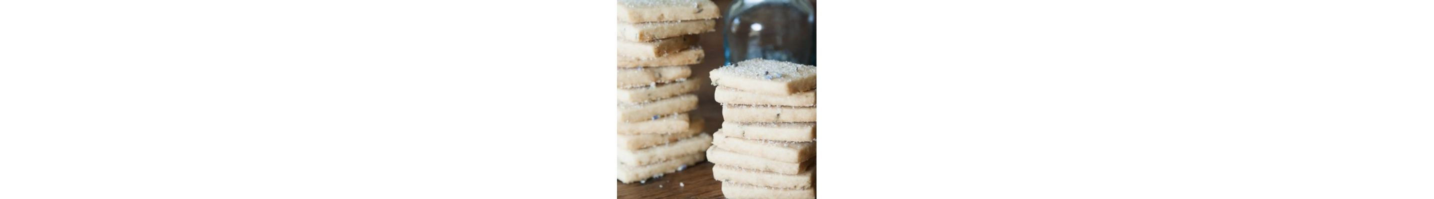 Stacks of lavender shortbread cookies on a countertop 