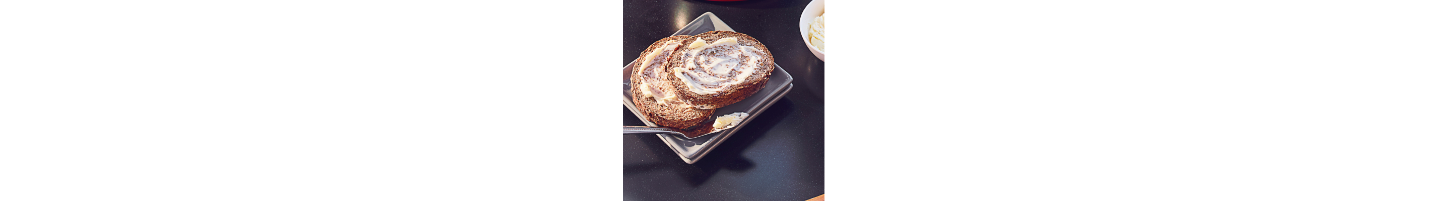 Light, whipped butter spread on slices of bread next to butter knife