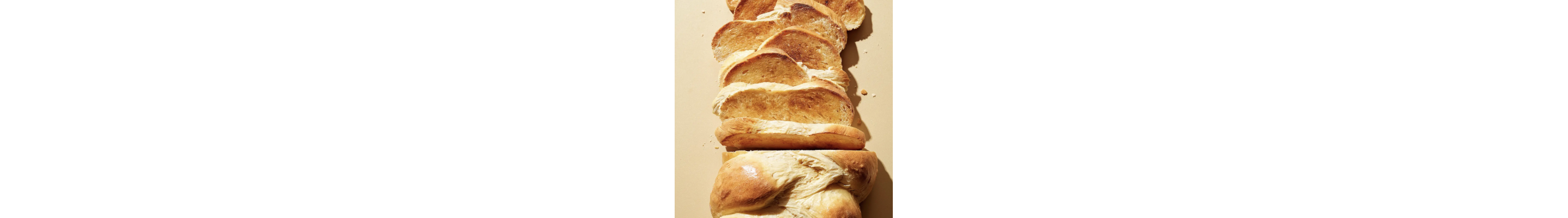 Sliced braided challah bread on a countertop