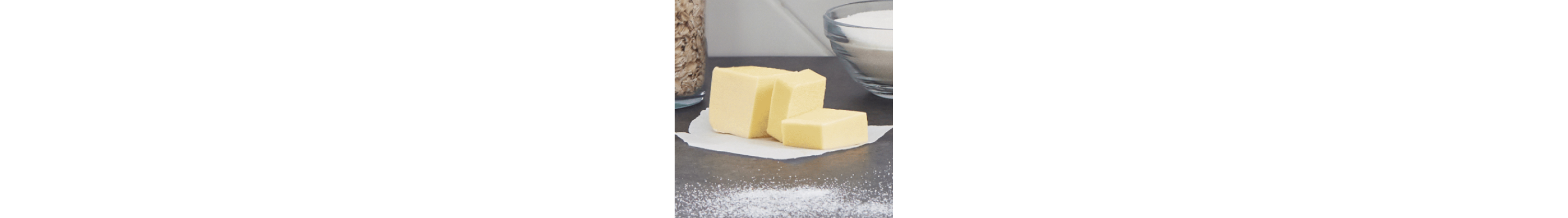 Butter on countertop cut into cubes with other ingredients