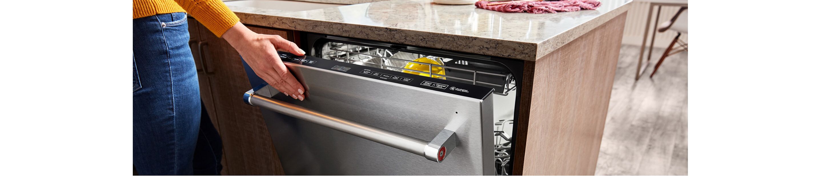 Person closing a KitchenAid® top control dishwasher