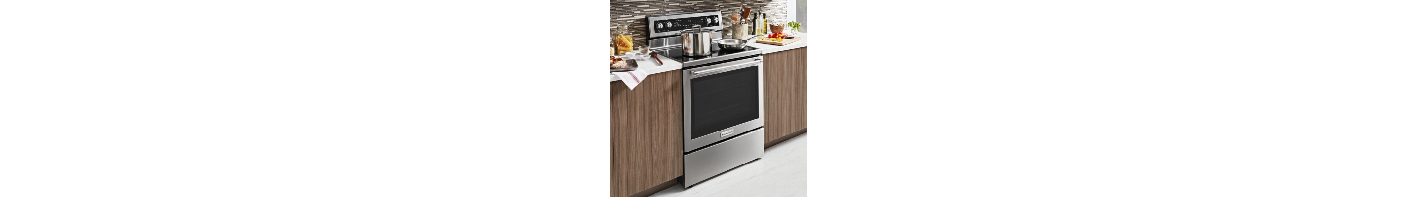 A pot and pan on the stovetop of a stainless steel KitchenAid® range