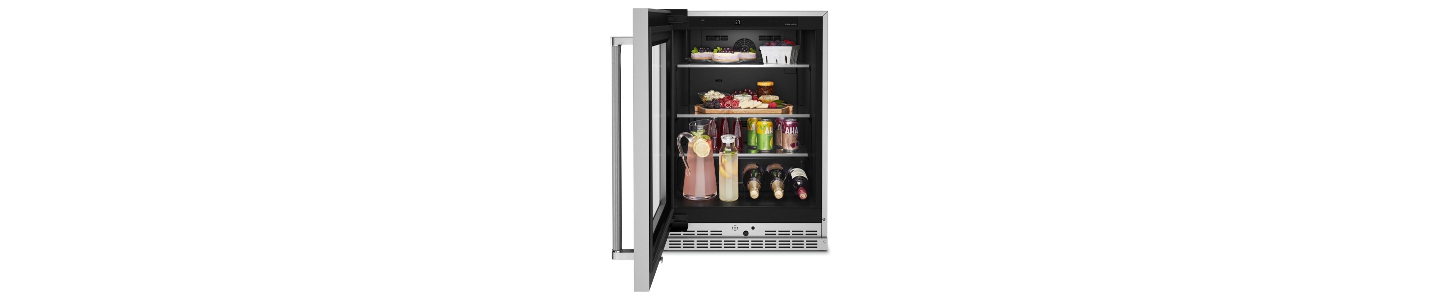 Open undercounter refrigerator with appetizers and drinks inside