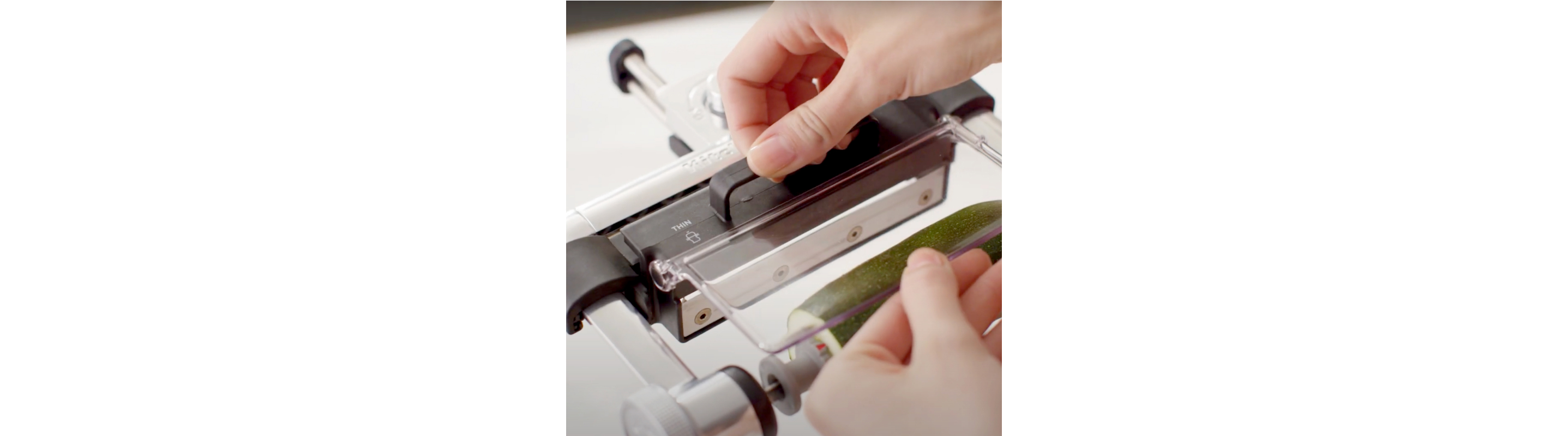 Person selecting the blade on a KitchenAid® Vegetable Sheet Cutter Attachment