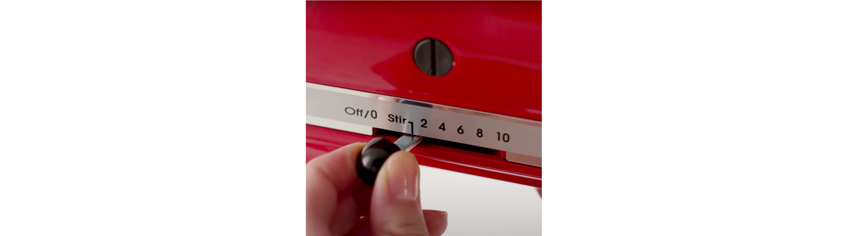 Person turning on a KitchenAid® stand mixer