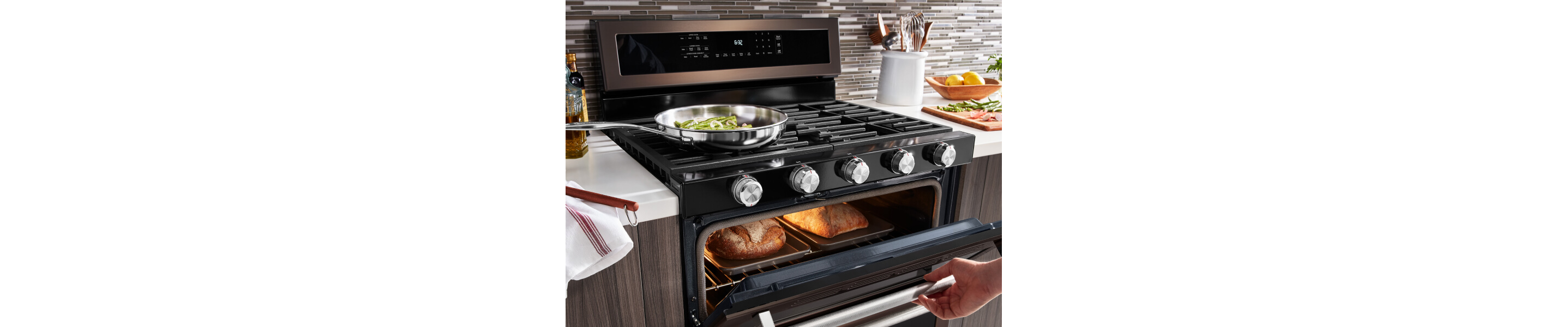 Vegetables cooking on a gas cooktop as bread bakes in the oven