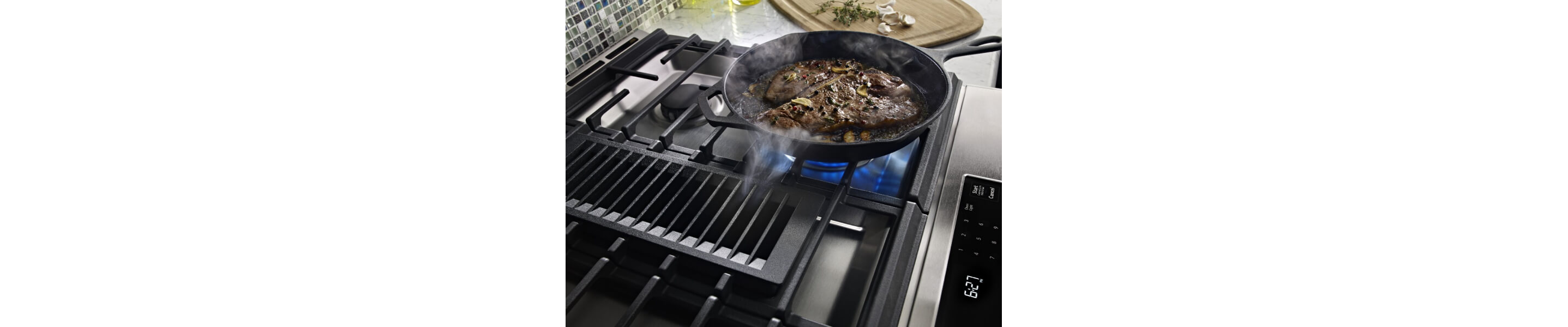 Steak cooking on a gas cooktop