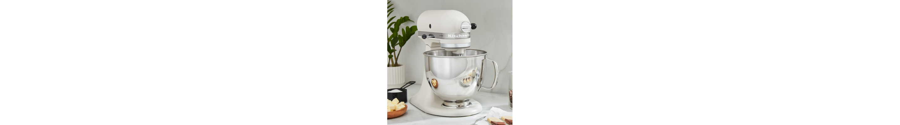 White KitchenAid® stand mixer with ingredients on counter