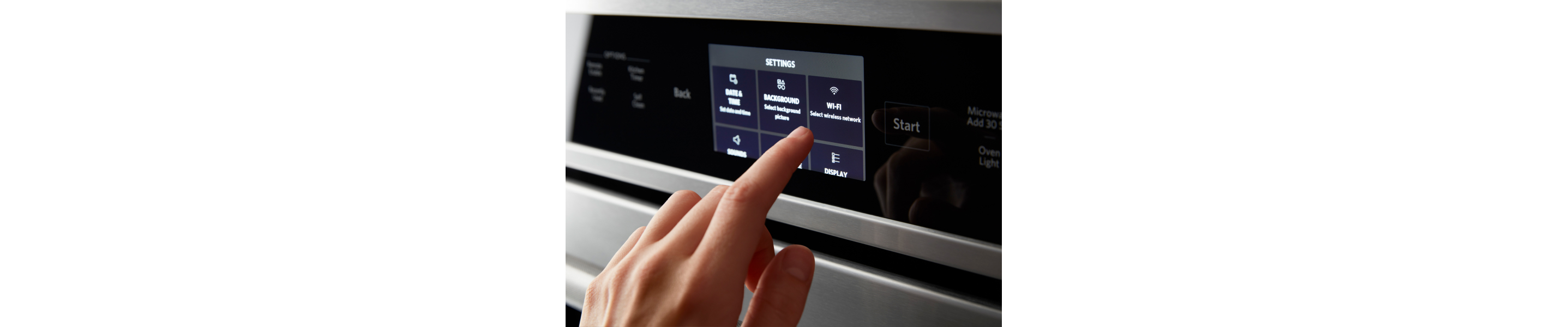 A person making a selection on the control pad of a smart oven