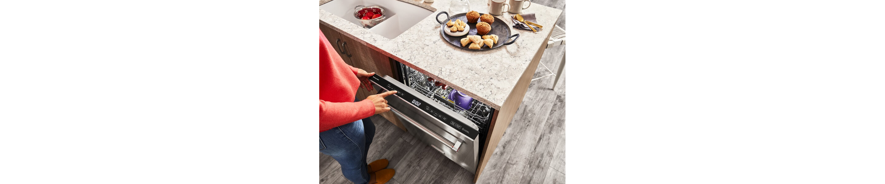 Person selecting settings on a KitchenAid® dishwasher