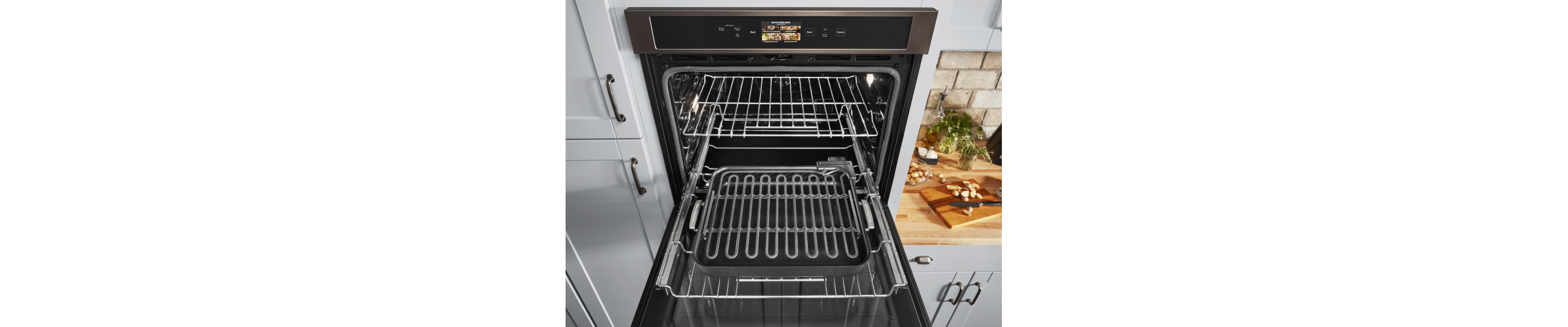 An open KitchenAid® wall oven in a modern oven.