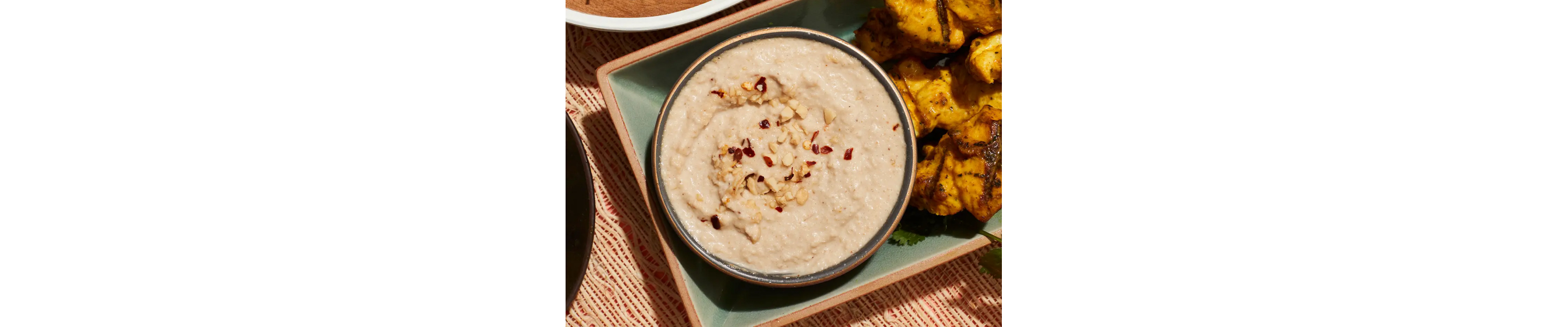 Homemade dipping sauce garnished with slivered nuts