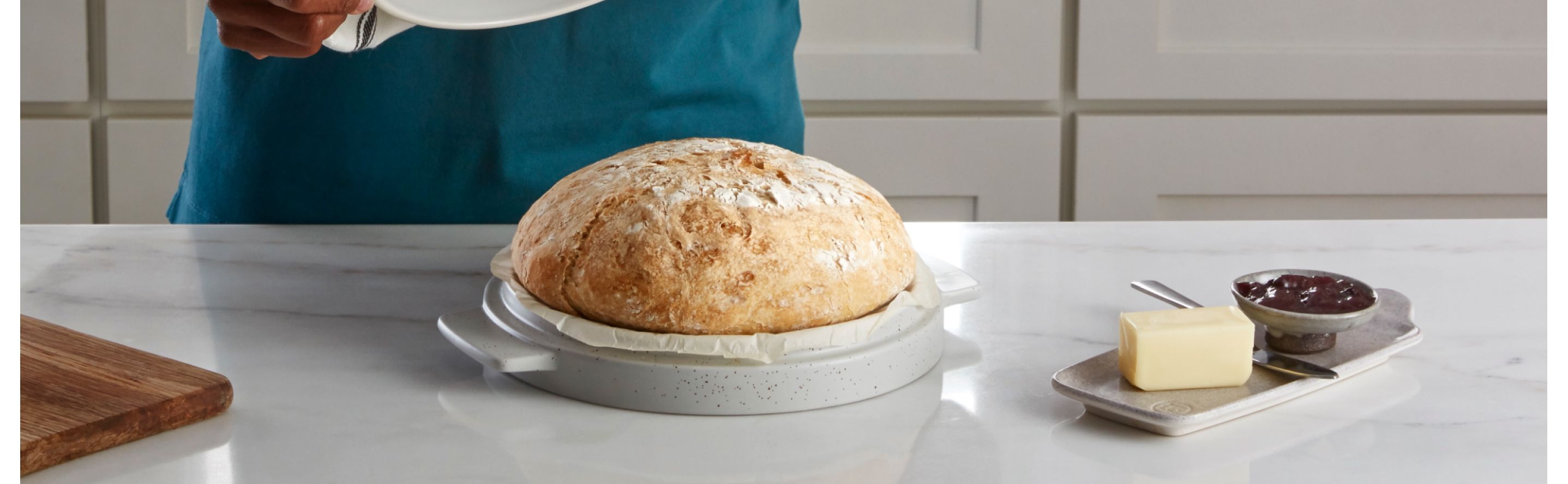 Homemade artisanal bread in a KitchenAid® Bread Bowl on a modern kitchen counter