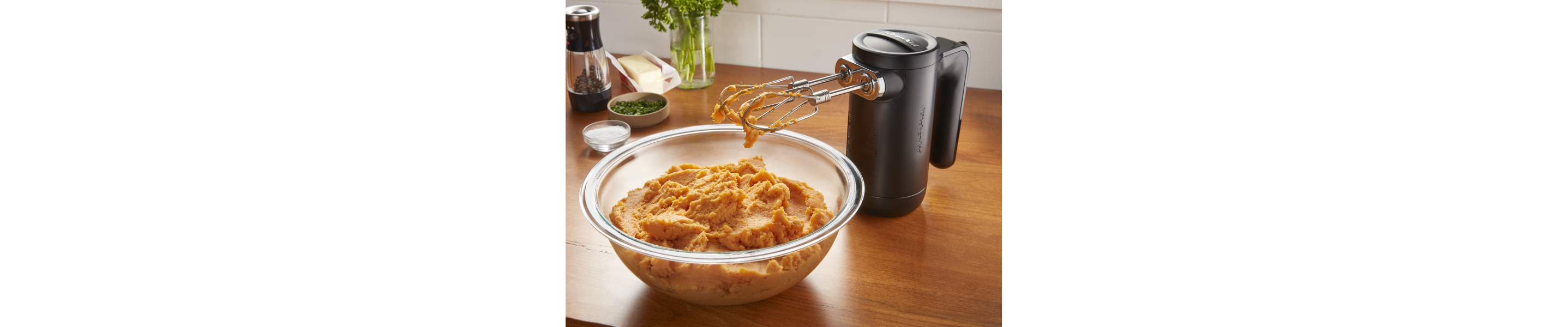  KitchenAid® hand mixer with bowl of pureed sweet potatoes