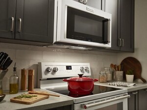 A kitchen with a white range and white over-the-range microwave