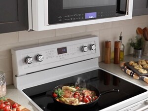 Food cooking on the burner of a smooth, white range
