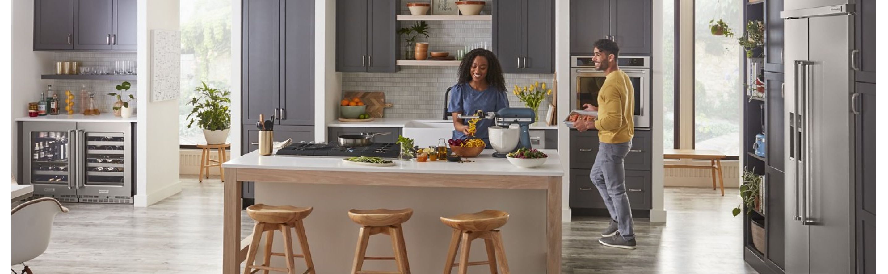 Two people in an open concept kitchen with a kitchen island