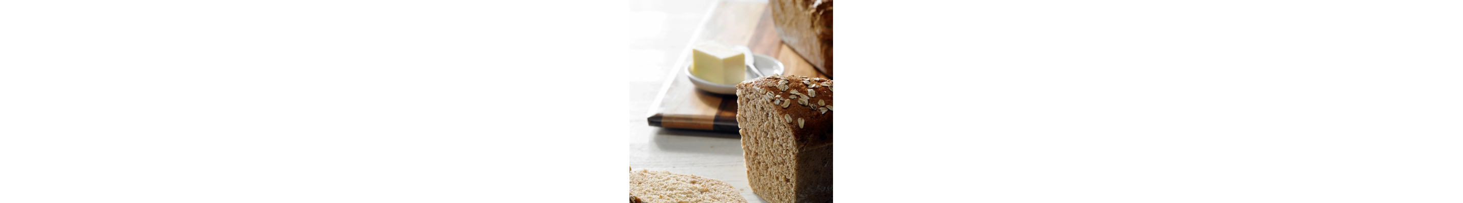 Multigrain bread next to a butter dish