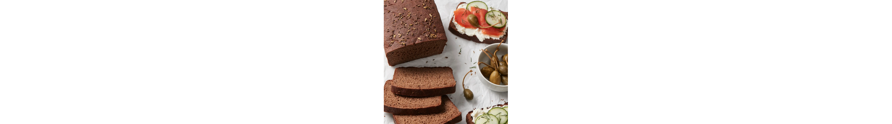 Sliced pumpernickel with cream cheese, lox and cucumbers