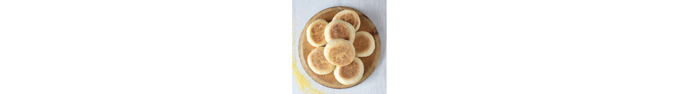 Wooden dish topped with english muffins