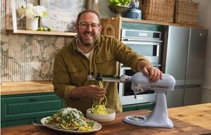Homemade founder Joel Gamoran using the spiralizer attachment on a blue salt KitchenAid®️ stand mixer