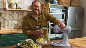 Homemade founder Joel Gamoran using the spiralizer attachment on a blue salt KitchenAid®️ stand mixer