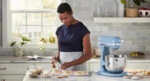 Person making tarts next to a stand mixer