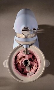 A person making ice cream using a KitchenAid® Stand Mixer
