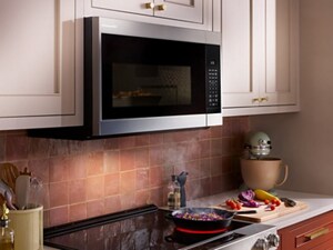 KitchenAid® over-the-range microwave above food cooking on the stovetop