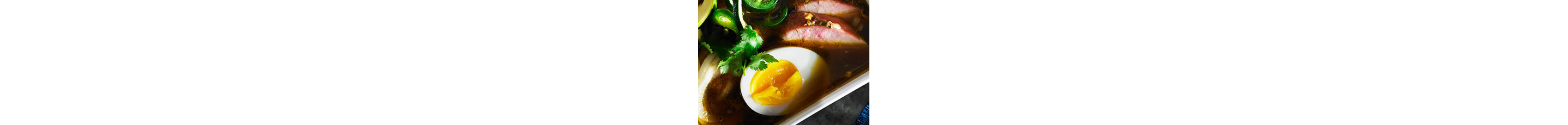 A rice bowl topped with ground pork, scallions and a soft-steamed egg.