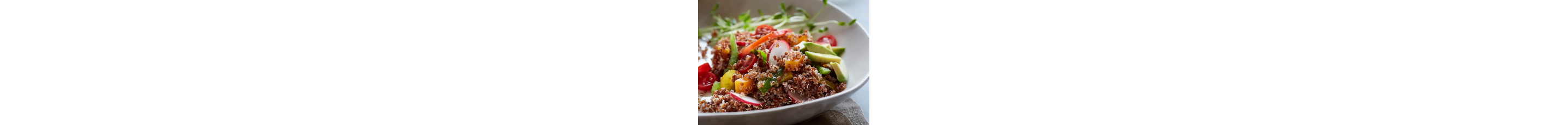 A colorful couscous based salad with cucumber, red onion and tomato.