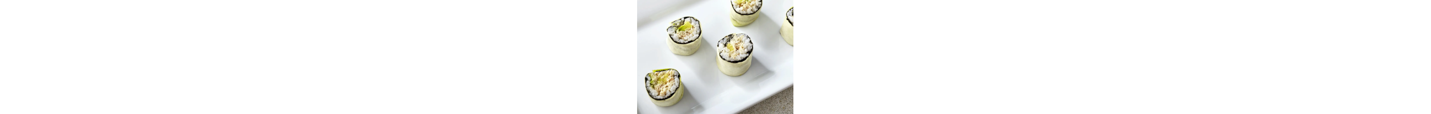 A serving platter filled with various types of sushi rolls.