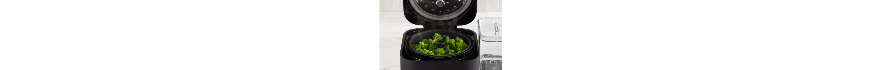 Broccoli florets in the steam basket of the Grain and Rice Cooker.