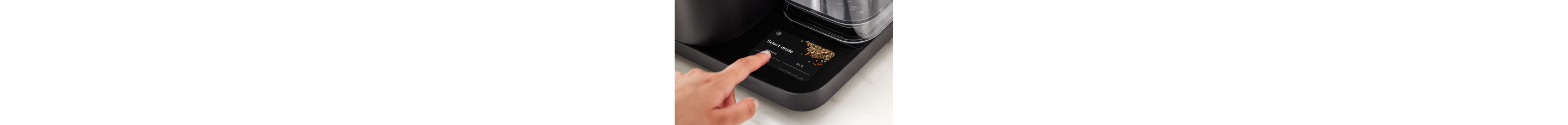 A person selecting a cycle on the touchscreen of the Grain and Rice Cooker.