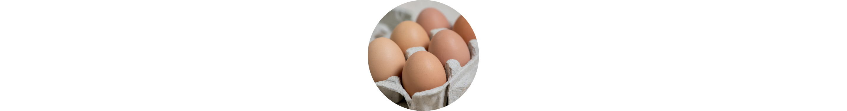 Light brown chicken's eggs in a cardboard package.