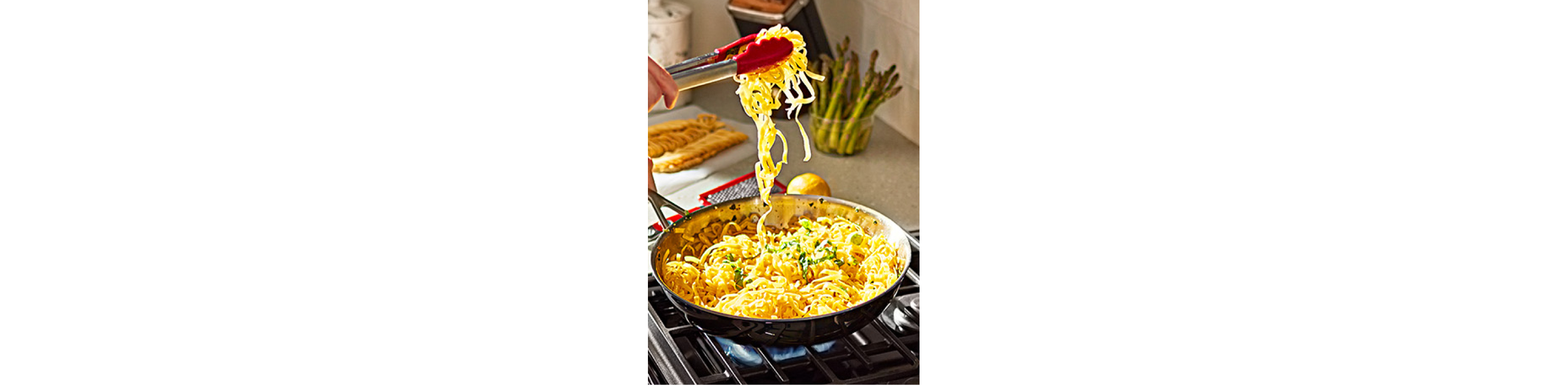 Person cooking on KitchenAId cooktop