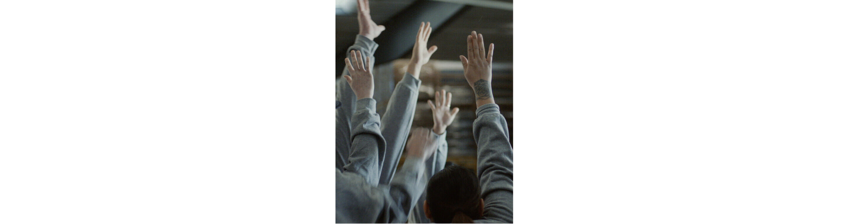 Workers eagerly raising their hands.