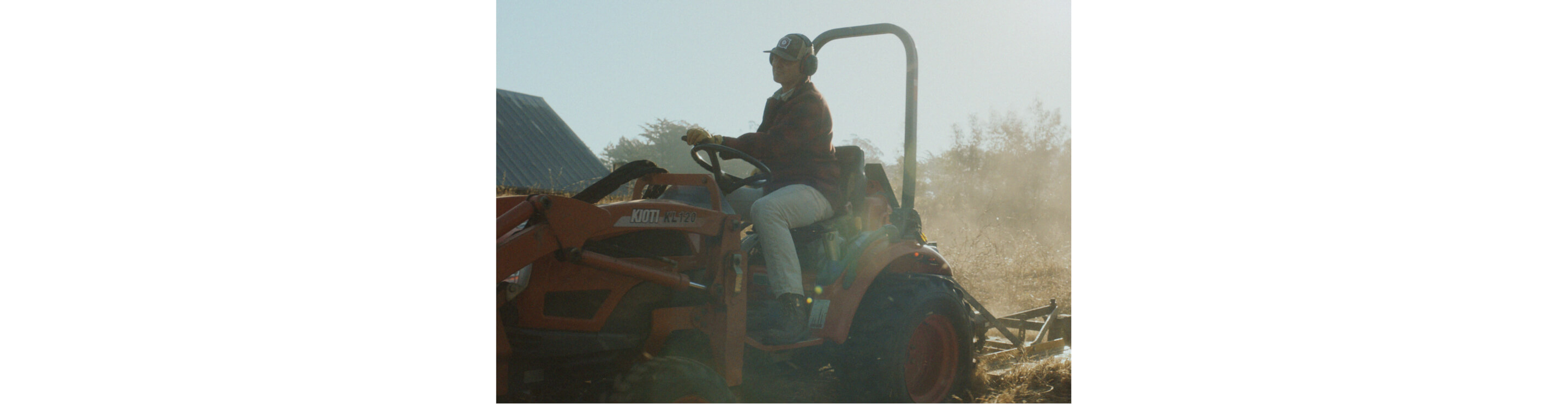 A man driving a small tractor.