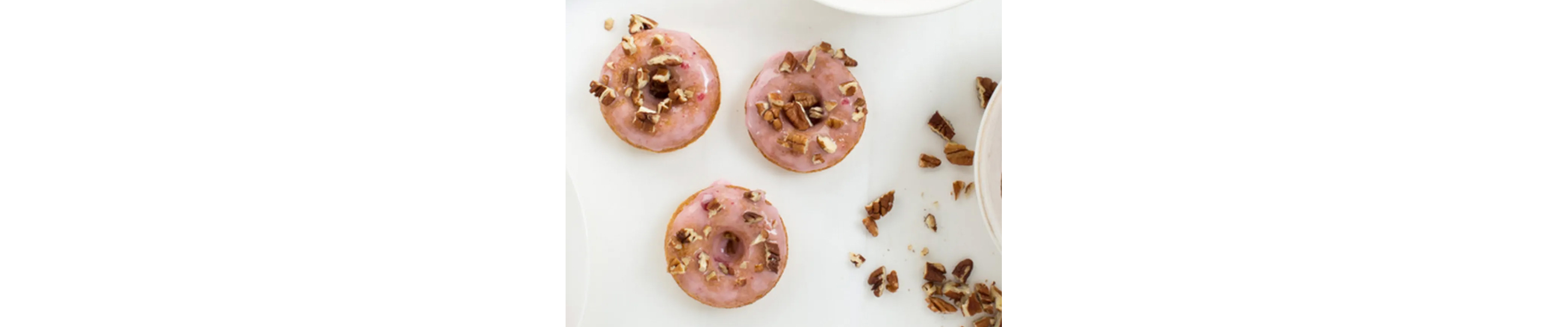 Donuts with pink glaze and pecans