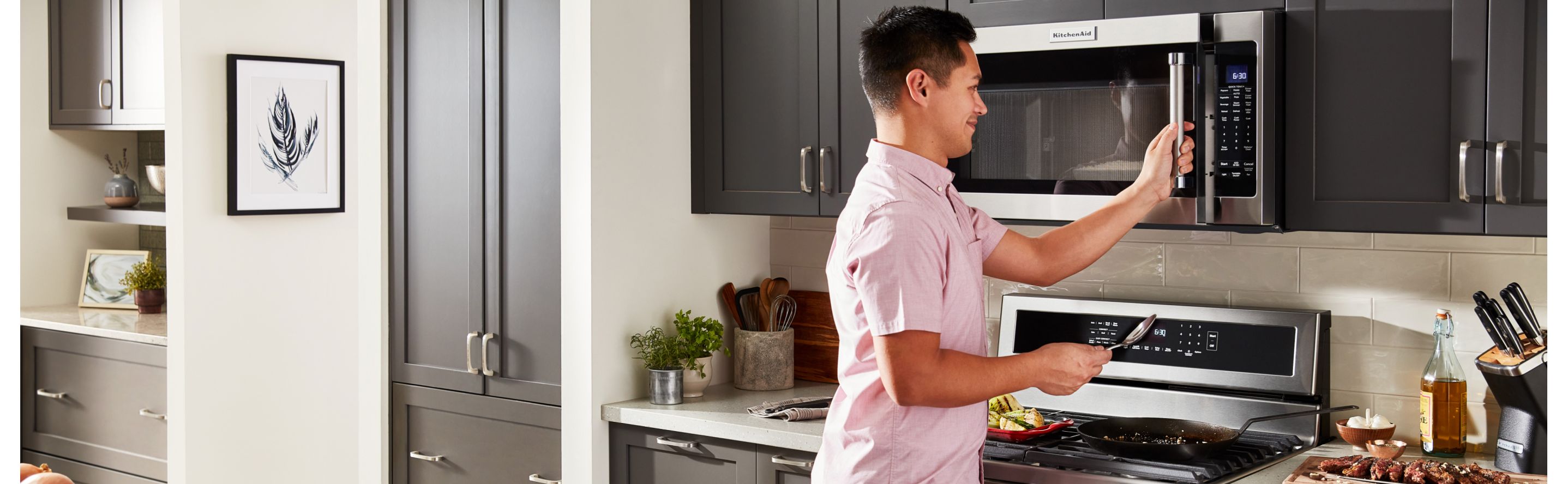 Person opening KitchenAid brand microwave