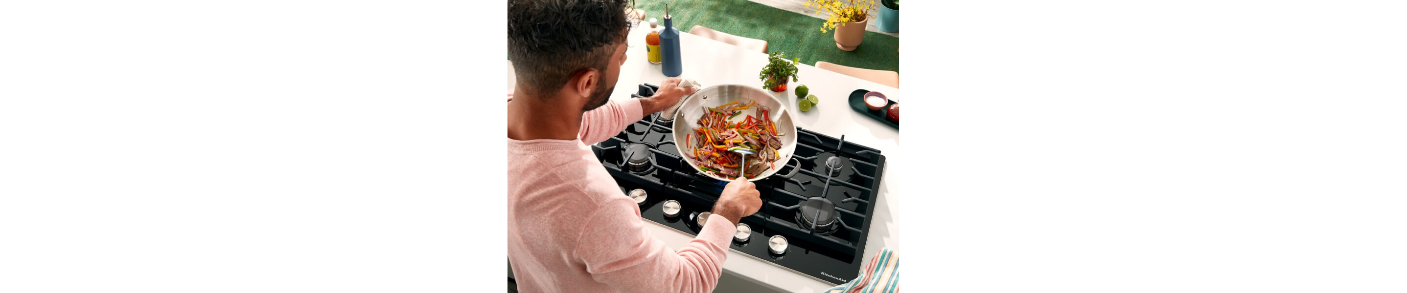 Person cooking on a gas cooktop